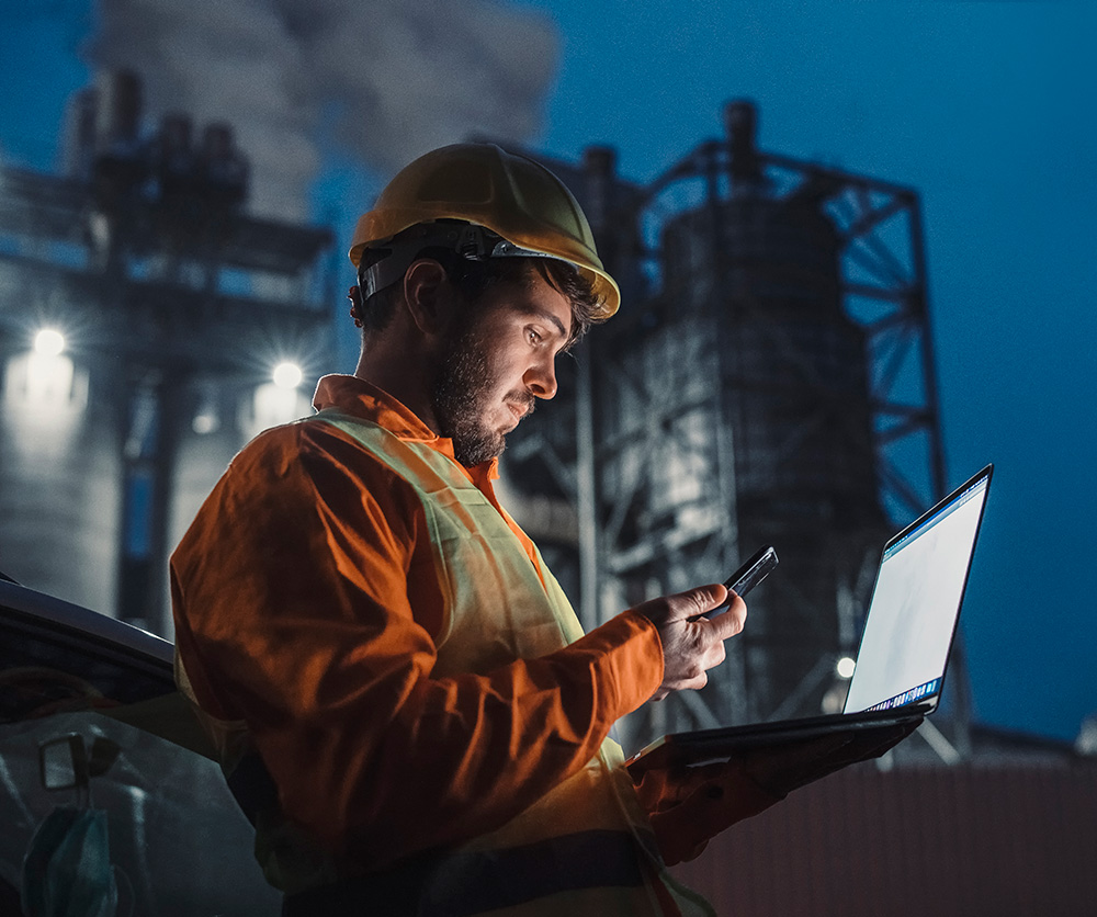 Offshore oil worker looking at laptop screen